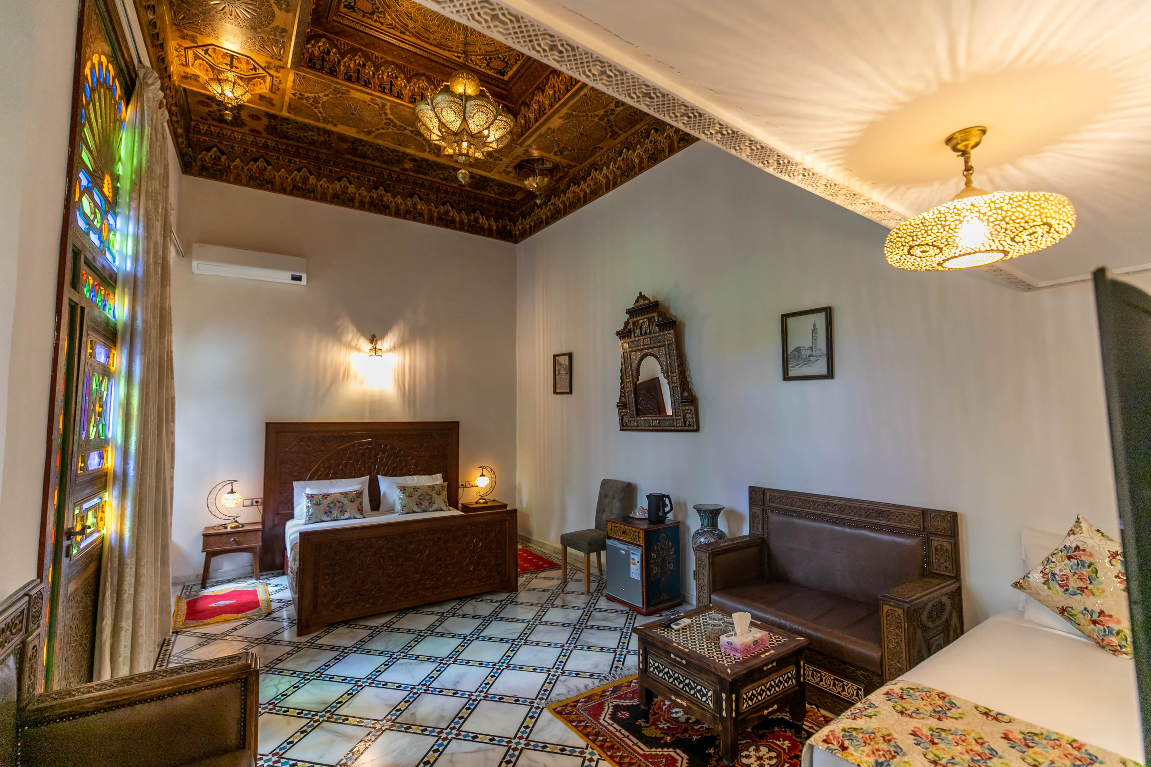 Riad Fez Mahal — ornate hand-painted cedar ceiling in Suite Kenza