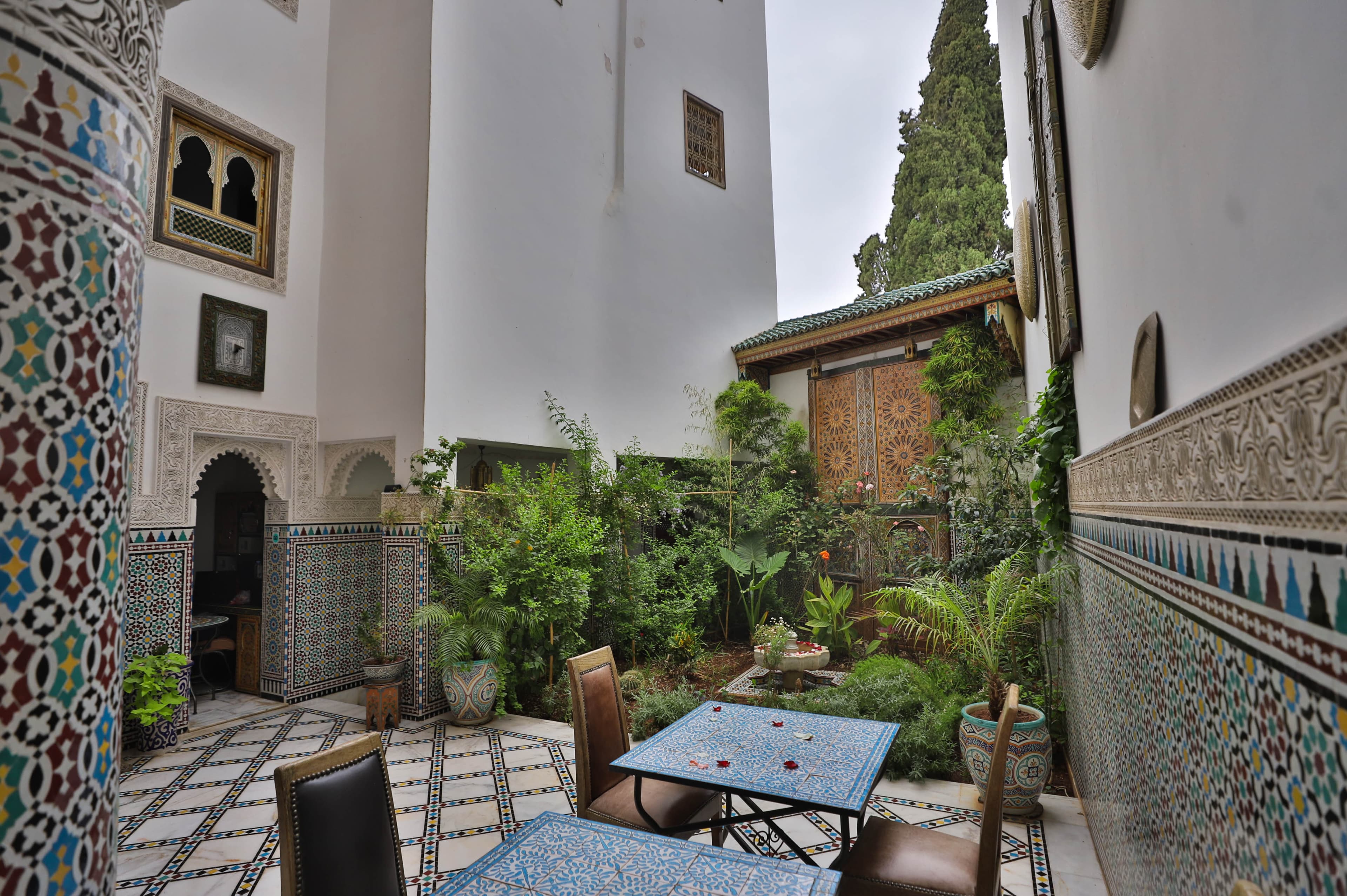 Riad Fez Mahal Andalusian courtyard with fountain and lush garden