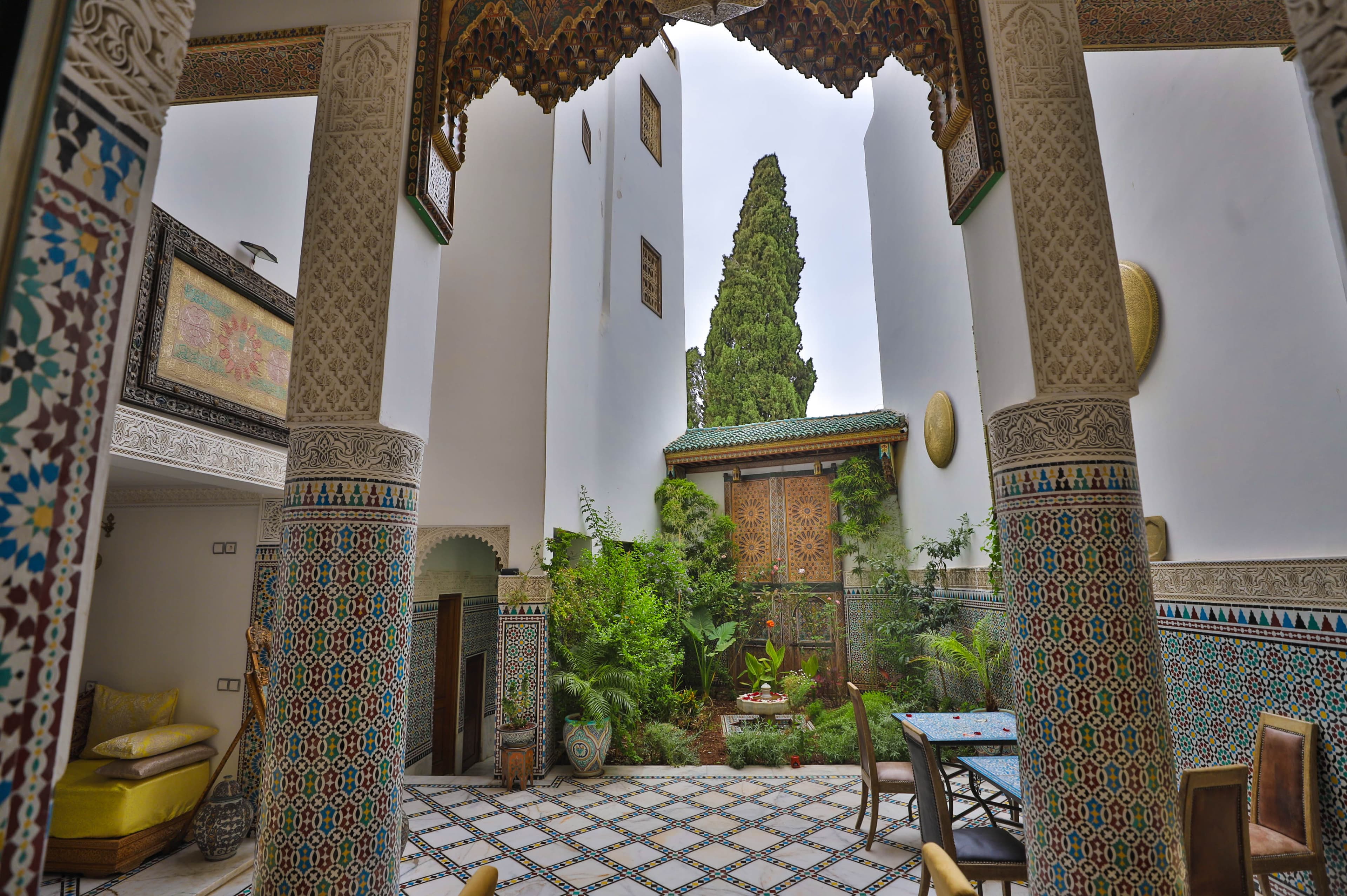 Riad Fez Mahal — Andalusian courtyard with zellige columns and lush garden